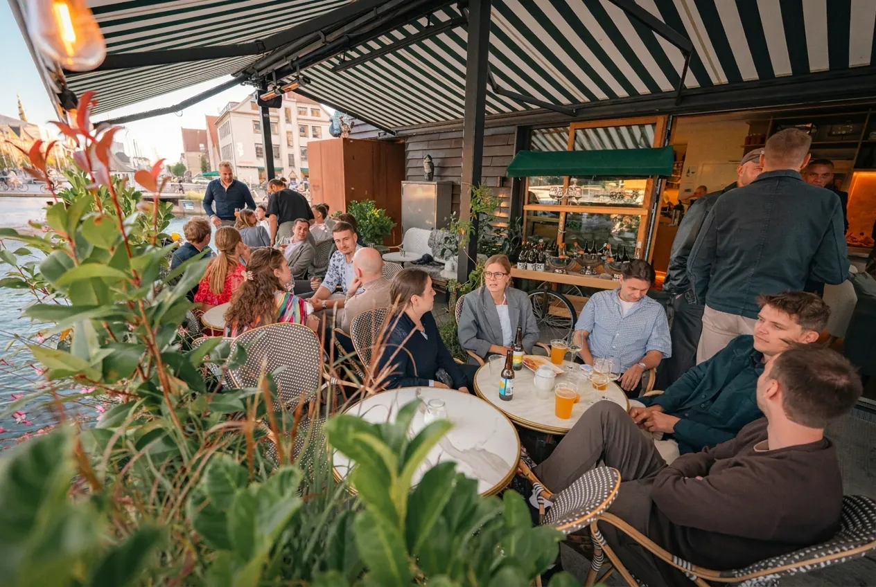 Guests at tables under awnings on the P88 terrace on Papirøen