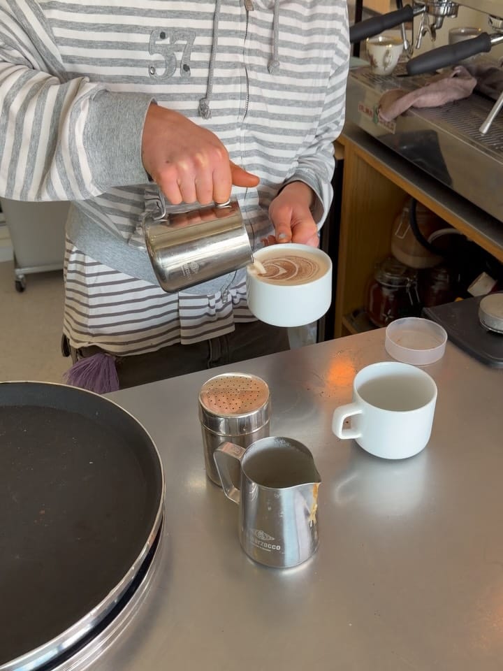 Latte art being poured into a cup at P88